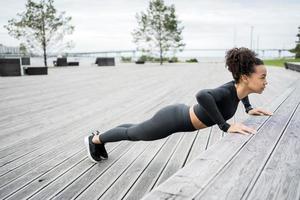 A female runner is running fitness training in a tight-fitting tracksuit. photo