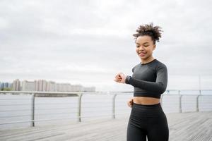 A female runner is running fitness training in a tight-fitting tracksuit. photo