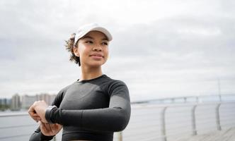 A female runner is running fitness training in a tight-fitting tracksuit. photo