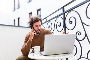 Adult serious man has business conversations using on-line mobile application. Developer innovational business web applications in the internet. Stylish guy. Business portrait. Cloud technologies. photo