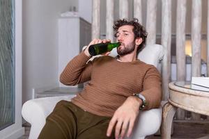 Sad sports fan sitting in an sofa and watching a match on television with his team losing the game . man watching football or soccer game on tv at home and drinking beer