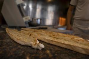 Turkish pide with cheese on counter at restaurant photo