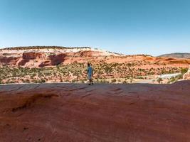 Young man standing in the Arches National Park in Arizona, USA. photo
