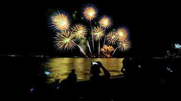 fireworks over the sea at night photo