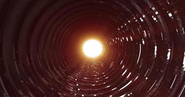 A rotating dark metal tunnel with walls of ribs and lines in the form of a circle with reflections of luminous rays. Abstract background photo