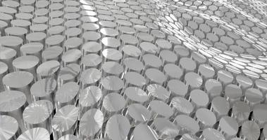 abstract grid of waves of round circles of cylinders of metal coins from stainless steel with reflections on iron. Abstract background photo