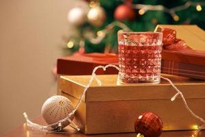 Decorated christmas tree with colorful balls and gift boxes at home photo