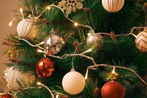 Decorated Christmas tree on blurred, sparkling and fairy background photo