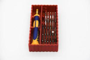 Screwdriver with replaceable heads on a white background. A set of screwdrivers. Repair kit. photo