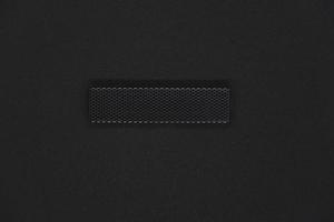 The iron panel from the computer. Iron black mesh panel. Metal rectangular panel on a black background. Beautiful iron rectangular black shape. photo