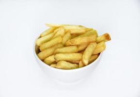 Yellow delicious French fries in white dishes. Fast food on a plate. Fried potatoes. Toasted potato slices on a white background. photo