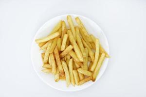 Yellow delicious French fries in white dishes. Fast food on a plate. Fried potatoes. Toasted potato slices on a white background. photo