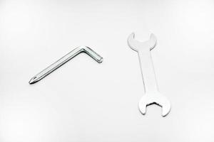 Two iron construction keys on a white background. A horn wrench and a screwdriver. photo