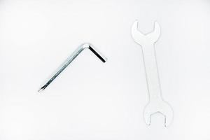 Two iron construction keys on a white background. A horn wrench and a screwdriver. photo