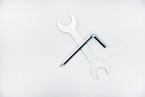 Two iron construction keys on a white background. A horn wrench and a screwdriver. photo