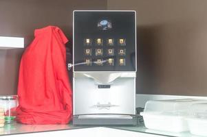 New automatic coffee maker or machine is serving customers or staff on table in car showroom or office. photo