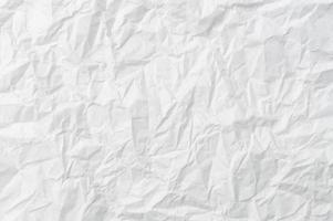 Wrinkled or crumpled white stencil paper or tissue after use with large copy space used for background texture in decorative art work photo