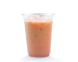 Orange Thai iced condensed milk tea in transparent plastic glass isolated on white background with clipping path photo