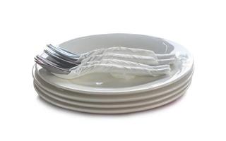 Tableware, white plates with spoons and forks nicely prepared at hotel or restaurant isolated on white background with clipping path photo