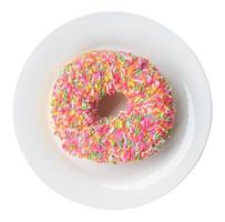 Top view of colorful glazed donut on white plate isolated on white background with clipping path photo