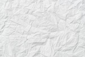 Wrinkled or crumpled white stencil paper or tissue after use with large copy space used for background texture in art work photo