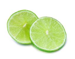 Close up photo of two slices of green lemon isolated on white background with clipping path