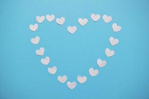 white hearts on a blue background. Valentine's day hearts pattern. Valentines day card with white hearts photo