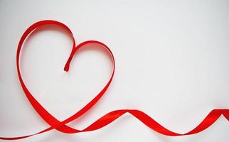 Red heart ribbon bow isolated on white background. Valentines day concept photo