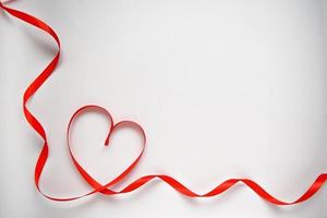 Red heart ribbon bow isolated on white background. Valentines day concept photo