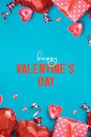 Happy Valentines Day greeting card vertical format. Gift box and red heart shape baloons on turquoise background photo