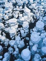 Beautiful air bubbles frozen in transparent ice. photo