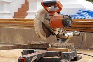 A miter saw is a tool that allows you to cut at various angles. You can use a miter saw to quickly cut picture frames, door frames, window frames, and more. Soft and selective focus. photo