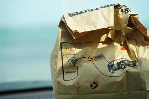 Mcdonald's meal bag on the car at the front of the beach. Khobar, Saudi Arabia, November,5,2022 photo