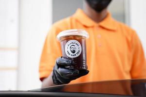 Cafe workers give orders at the drive-thru. Lemonade ice tea.Abo Saif Tea is a Saudi local brand based in al Khobar. Khobar, Saudi Arabia, 22 December 2022. photo