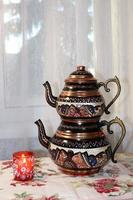 photo of Turkish teapot and candle