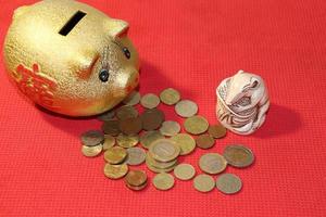 piggy bank and money mouse mascot on red photo