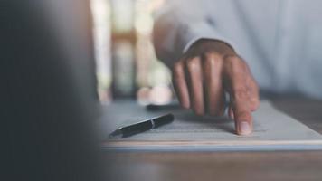 Businessman pointing at document ,Management of business documents and agreements, signing of business contracts, approval of contract documents or warranty certificates,Document Management photo