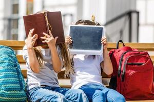 Back to school. Happy children ready for primary school. Pupil on first day of classes. girl with backpack and book on backyard. Education for kindergarten and preschool kids. photo