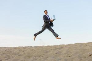 Happy businessman jumping in the air photo