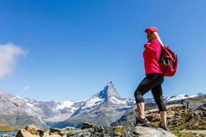 Traveler in the Alpine meadow, Switzerland photo