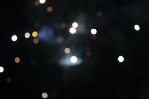 On a black background bokeh from explosions of colorful fireworks. photo