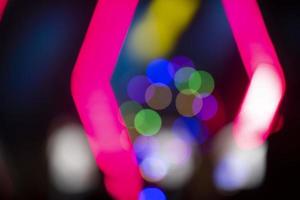 Multi-colored bokeh spots on a dark background. Festive blurred background. photo