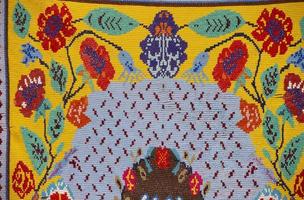 Traditional Slavic ancient embroidered bedspread. Ethnic Ukrainian or Belarusian pattern on the fabric. photo