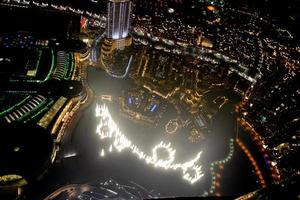 Aerial view of the skyline in Dubai, United Arab Emirates at night photo