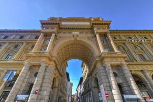 Florence, Italy - Mar 22, 2018 -  Triumphal Arch in Piazza della Republica Florence, Italy. Arch inscription says The ancient centre of the city, Restored from age-old squalor to new life. photo