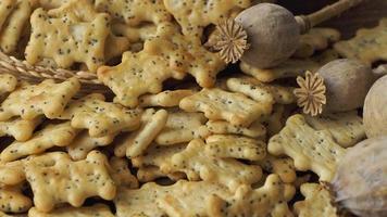 Baked party poppy seed crackers, dry poppy heads . Salty snacks video