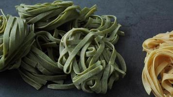 Fresh homemade green and yellow pasta tagliatelle. Raw homemade spinach pasta. video