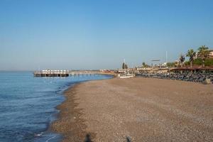 Scenic and tranquil view of seascape and sandy beach during sunny day photo