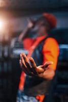 Having vocal practice. Young african american performer rehearsing in a recording studio photo