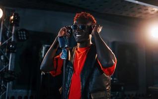 Young african american performer rehearsing in a recording studio photo